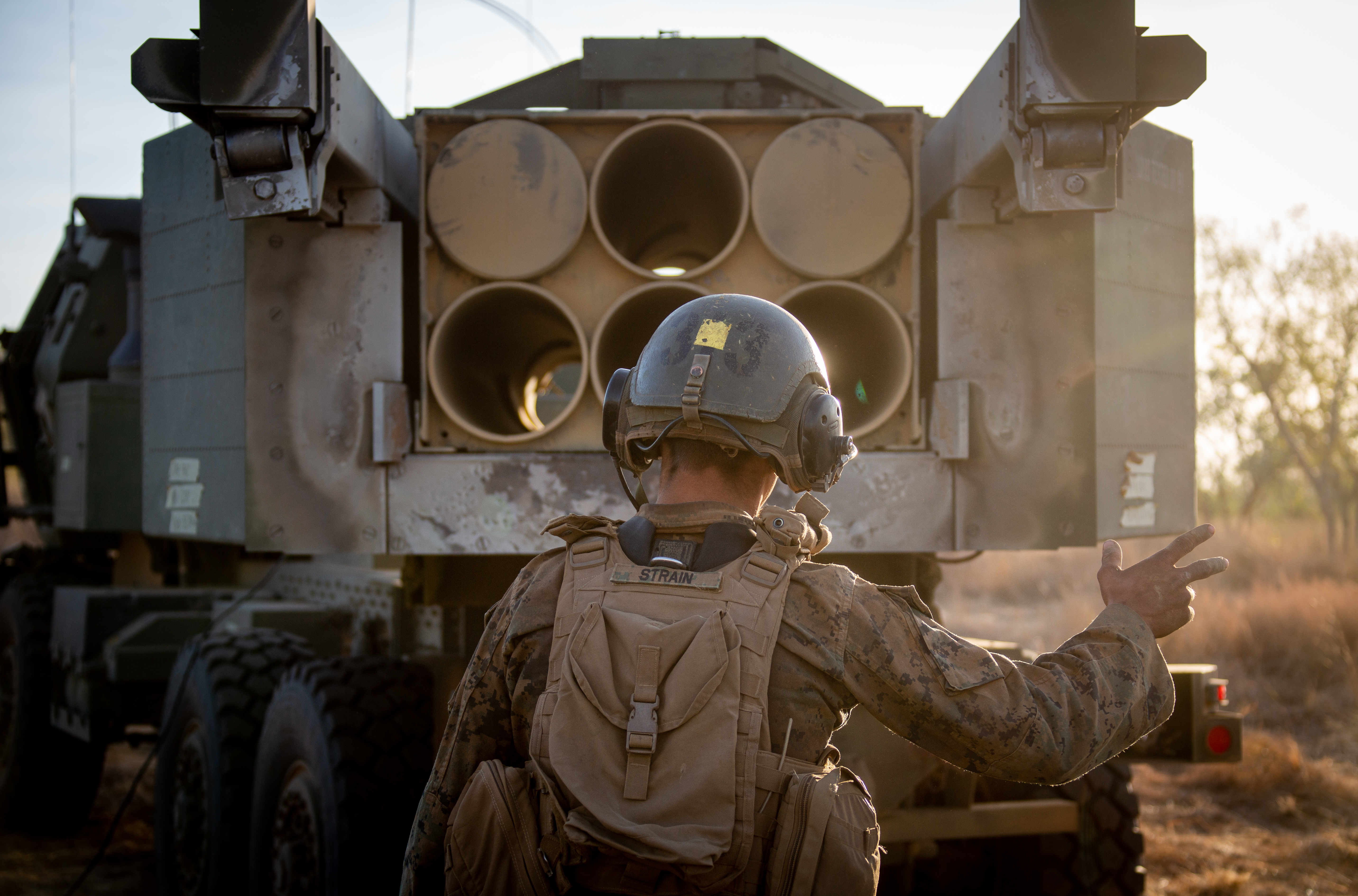 Marine Corps Corporal Cole Strain, High Mobility Artillery Rocket System launcher chief with HIMARS platoon, Marine Rotational Force–Darwin, loads Guided Multiple Launch Rocket System into launcher before emergency fire mission during exercise Koolendong at Bradshaw Field Training Area, Northern Territory, Australia, August 29, 2021 (U.S. Marine Corps/Colton K. Garrett)
